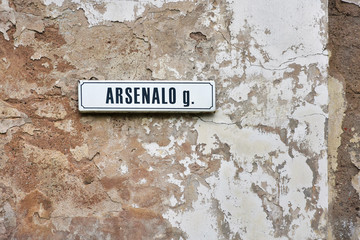 Signboard with name of the street in Vilnius, lithuania. Signboard on the old grunge wall with name of the street Arsenalo in Vilnius. Street name sign on Arsenalo in the old town. Famous location 