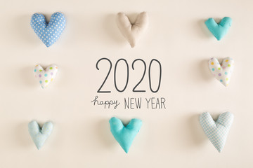 Happy New Year 2020 message with blue heart cushions on a white paper background
