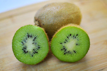 Kiwi fruits on brown cutting board