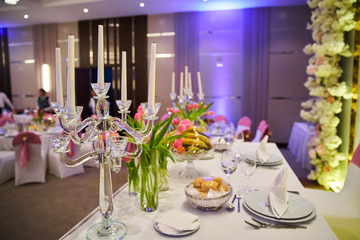 Decoration for a wedding, a table of the newlyweds, candles on the stole and flowers