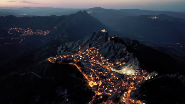 Picturesque mountain town Pietrapertosa located in Dolomiti lucane mountains in Basilicata region in the southern Italy. Aerial blue hour shot. 