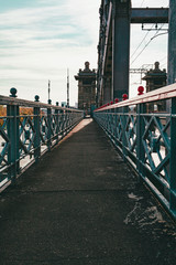 The railing of the pedestrian bridge across the river
