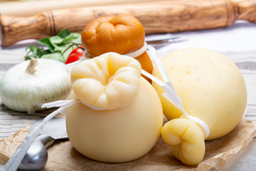 Italian provolone or provola caciocavallo hard and smoked cheeses in teardrop form served on old...