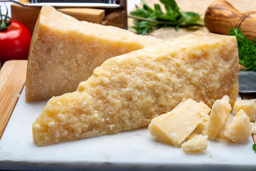 Italian original aged Parmesan cheese in two pieces close up