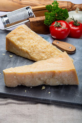 Italian original aged Parmesan cheese in two pieces close up