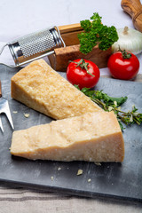 Italian original aged Parmesan cheese in two pieces close up