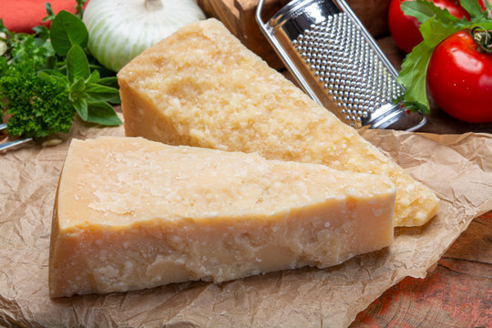 Italian original aged Parmesan cheese in two pieces close up