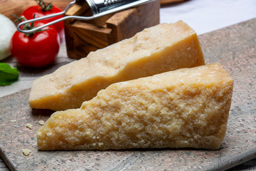 Italian original aged Parmesan cheese in two pieces close up