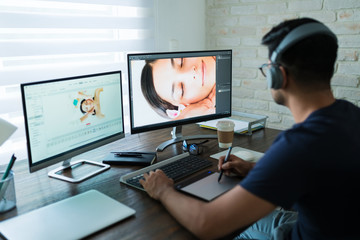 Young Freelancer Retouching While Working At Home