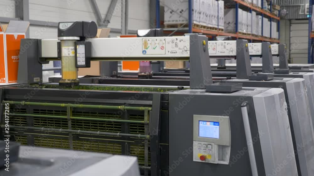 Poster a static footage of the slow movement of colored cartridges of printing machines at printing house s