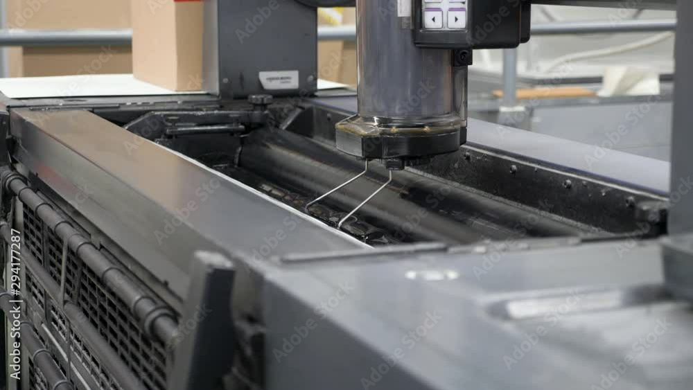 Poster a slow motion close up footage of the movement of cartridges of printing machine at printing press s