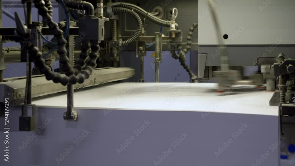 Poster a static footage showing a machine with stack of large sheets of papers at the printing house.(1)