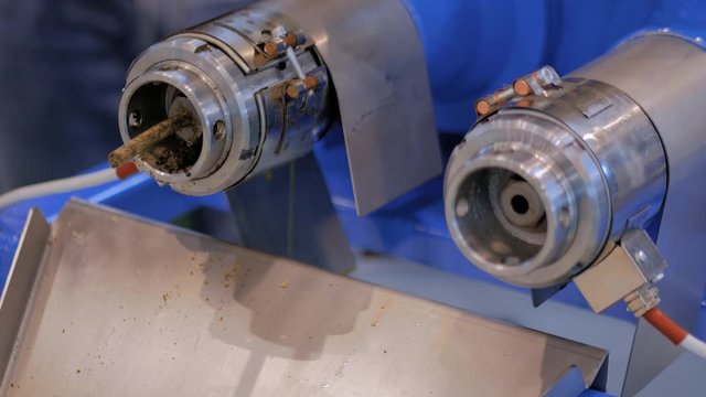 Close up view - pet food and oil extruder machine: mixed feed production line at factory, plant, exhibition, trade show. Farming, extrusion technology, agriculture industry, animal husbandry concept