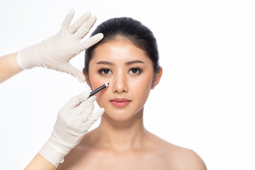 Lines on face, close up, plastic surgery concept, doctor's hand in glove making marks on patient's face..Asian beauty  Woman in beauty salon. plastic surgery clinic.