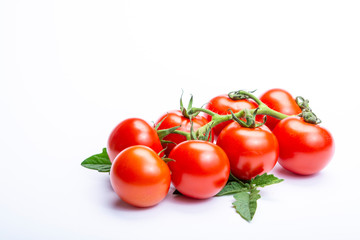 Bunch of fresh ripe red tomatoes with leaves isolated on white background