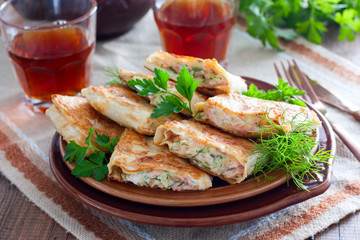Squares of fried pita bread with sausage and cheese, horizontal