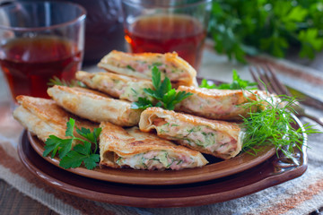 Squares of fried pita bread with sausage and cheese, horizontal