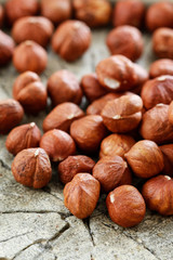 Hazelnuts on rough wooden background.