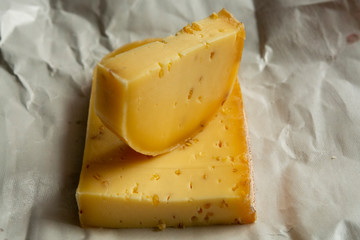 Piece of cow cheese with fenugreek seeds made in Belgian abbey by monks.