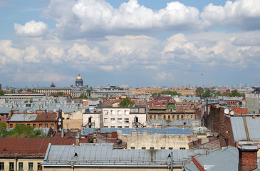 Fototapeta premium Roofs of St. Petersburg downtown, view of old houses roofs from the height, St. Petersburg, Russia. View of Saint Isaac's Cathedral from the roof cloudy