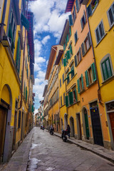 colorful streets of Florence with motorcycles on a sunny day