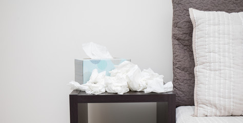 A pile of dirty kleenex on nightstand