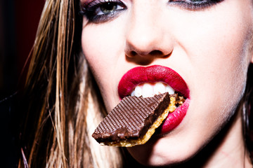 Luxury girl with chocolate chip cookies in the mouth. Diet for models. Sweets for the girl....