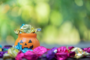 Fototapeta premium Halloween jack-o-lantern pail with spilling candy