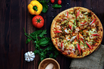 Italian Pizza With tomatoes, peppers, onions, garlic  it On a black background