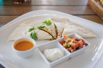 Chicken quesadilla with salsa and cheese.  Mexican cuisine, food background.
