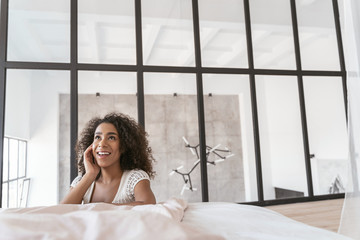 Pleased brunette female person looking upwards at ceiling