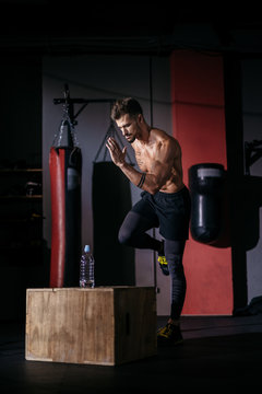In the dark cross fitness class bodybuilding guy take the running poses then start to run doing his hard workout we ll get sweating