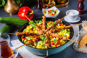 Lamb skewers with curry rice and different vegetables
