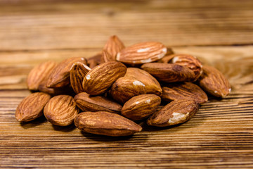 Heap of the peeled almond nuts on wooden table