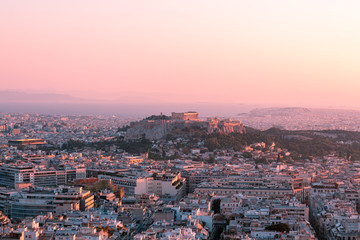 Bright panorama of Athens at sunset, red pink sky and ancient city