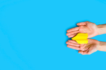 Origami paper airplane on blue background