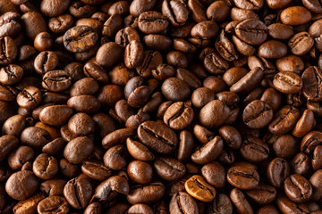 A lot of coffee beans. Seamless background from arabica beans. Fried arabica beans.