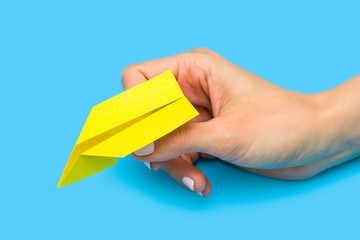 Origami paper airplane on blue background