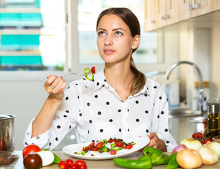 Female holding plate of vegetable salad