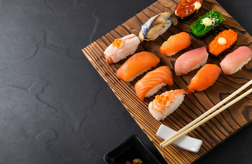Sashimi sushi set with chopsticks on wood plate