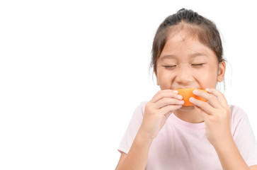 little cute asian girl enjoy eating sliced orange