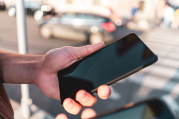 guy holds two smartphones in his hands.