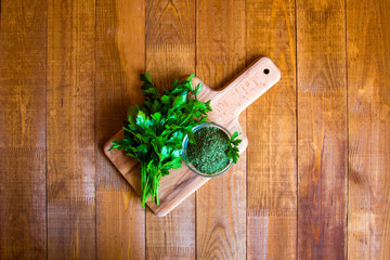 Dried parsley seasoning on wooden table