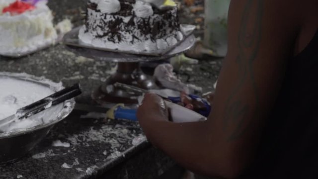Medium shot of baker preparing tools and decorate birthday cake