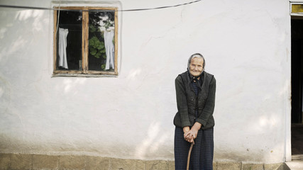 Grandmother in an old house in the village