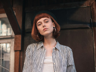 Fashionable young woman standing on the porch.