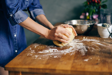 Young adult woman cooking holiday cookies in winter season at home