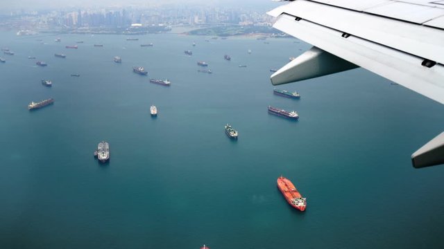 Traveling by air. View singapore bay through an airplane window. Airplane is about to land in Singapore airport