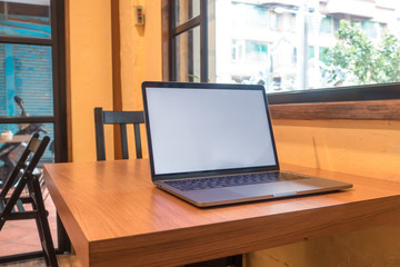 Conceptual workspace, Laptop computer with blank white screen on table, blurred background. use in Traditional Chinese Alphabet operating system.