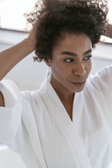 Beautiful girl setting her hair in the morning